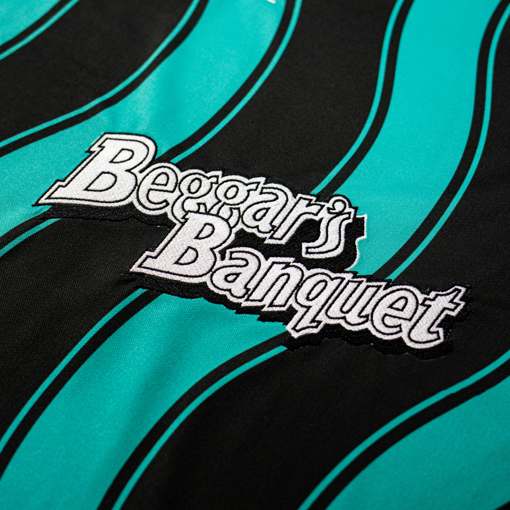 Beggars Banquet Vintage Teal + Black Wave Football Shirt - War Child